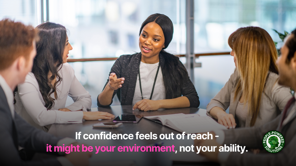 women at conference table smiling and speaking to 2 female and 2 male colleagues