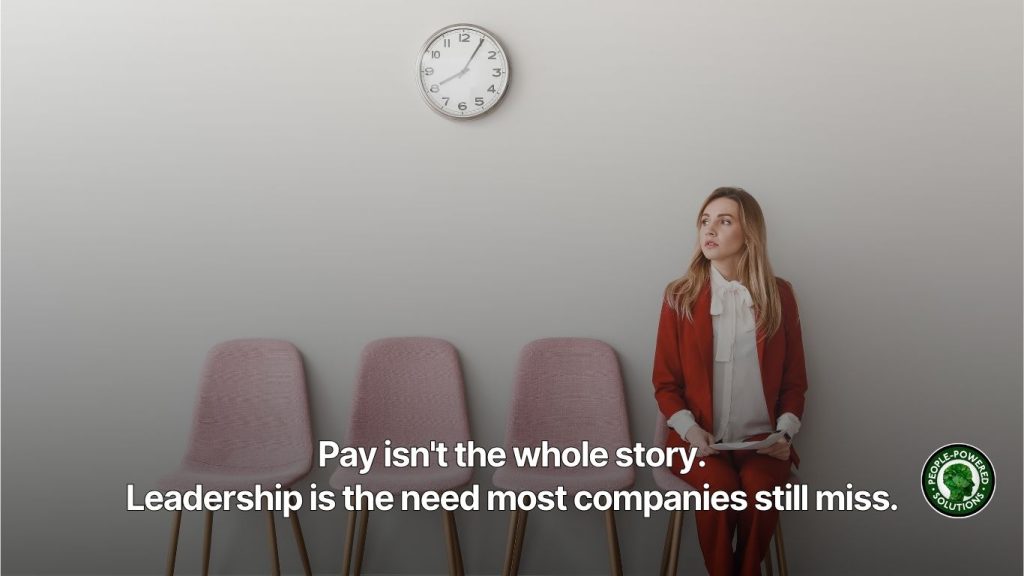 An employee sitting in a row of chairs waiting for an exit interview